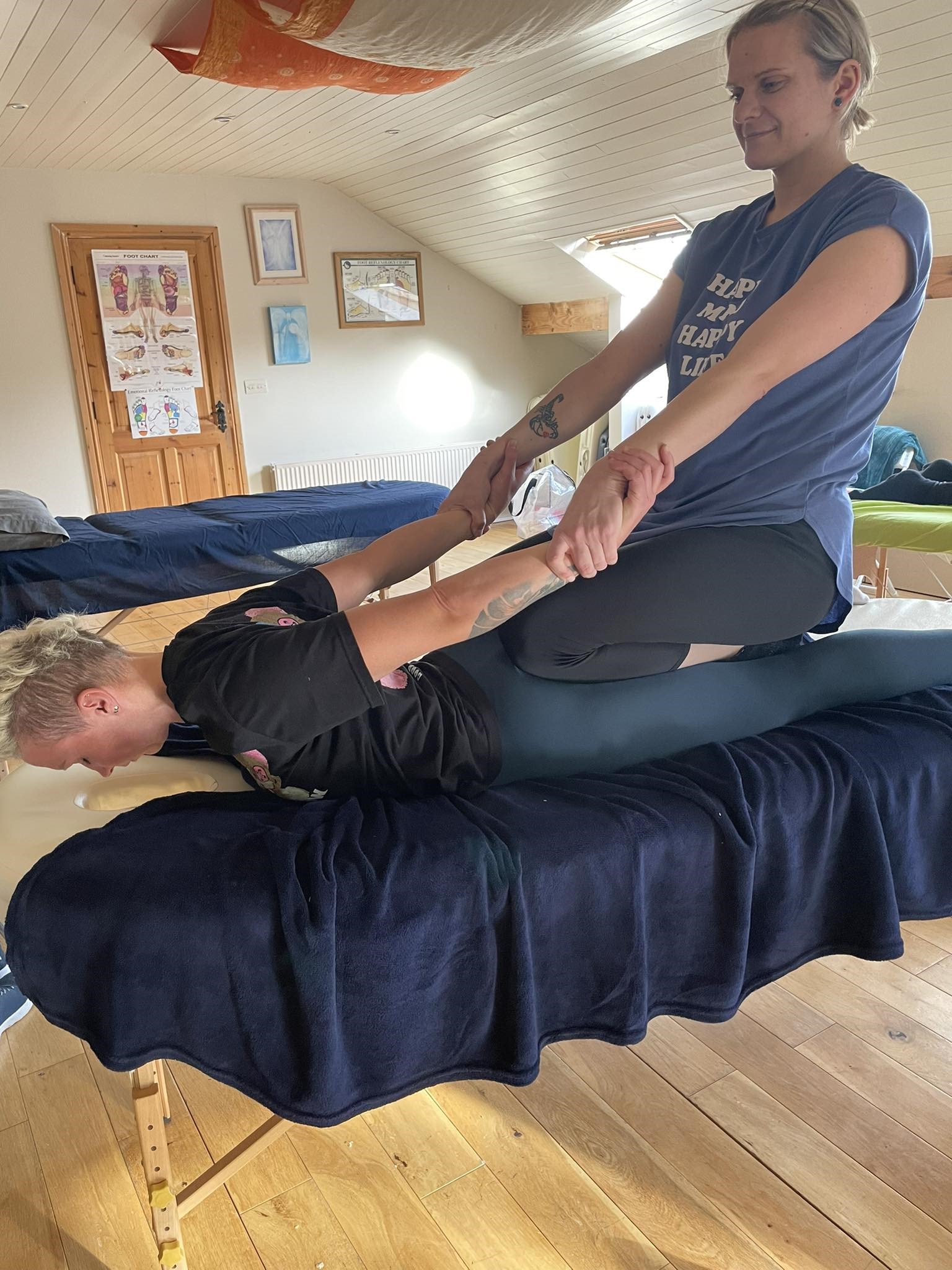 Baiba performing table thai massage by stretching arms